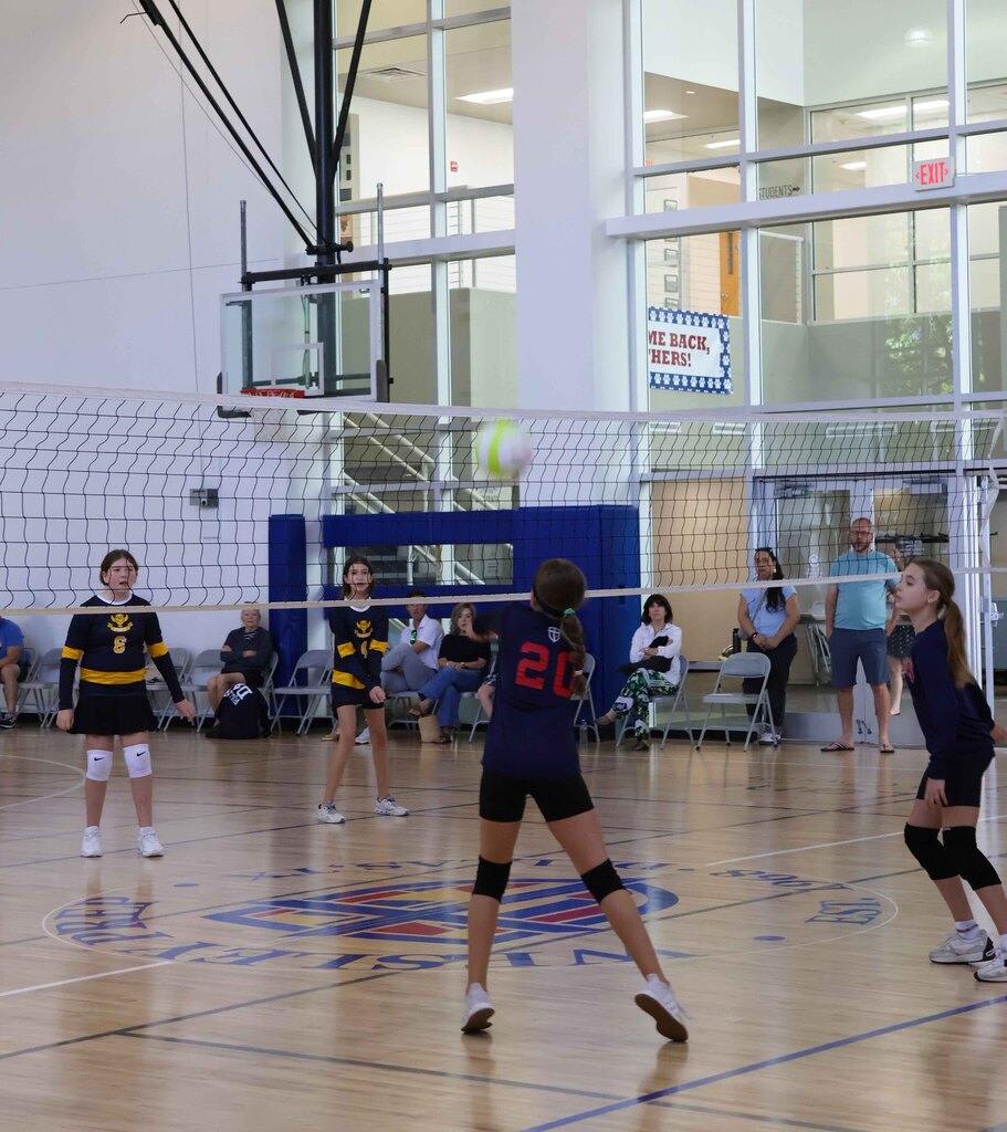 Hitting the volleyball over the net.