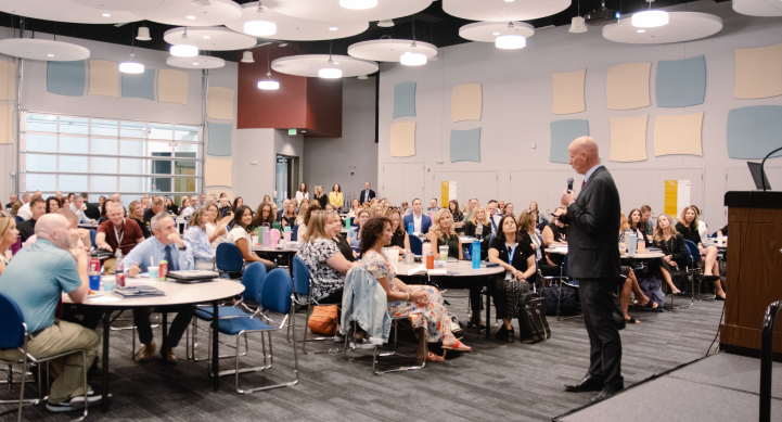Image of Dr. Bub speaking to WASD teachers at a training in the White Cloud Auditorium