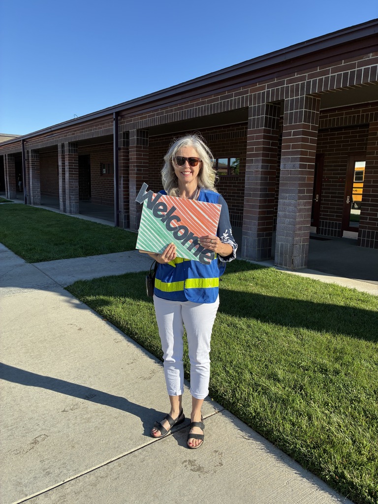 woman holding sign that says welcome
