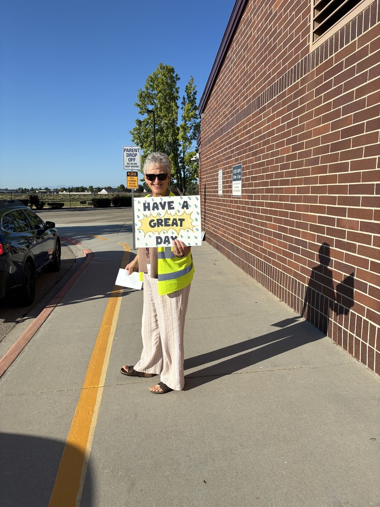woman holding sign that says have a great day
