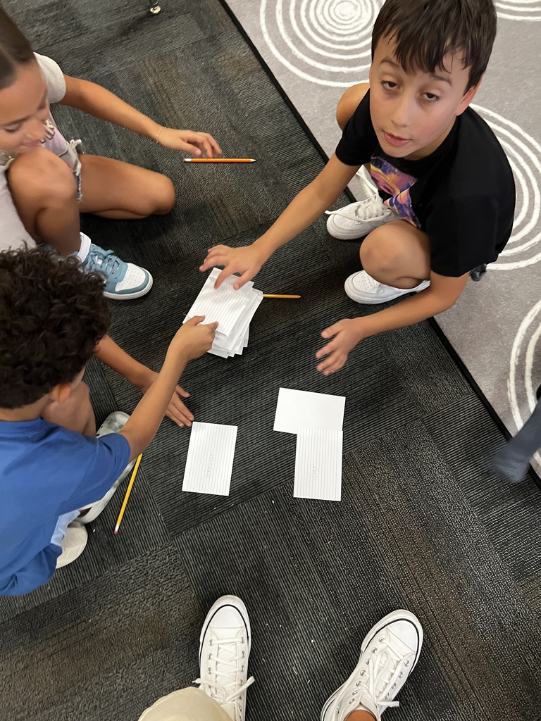 Students working together on the rug
