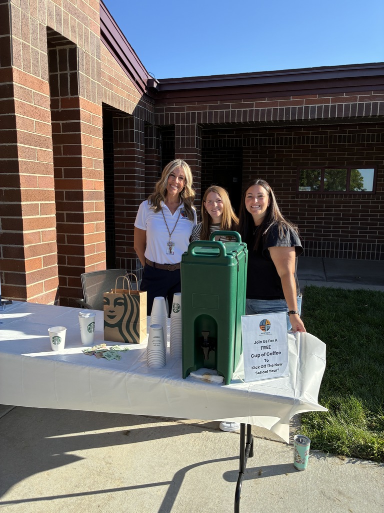 3 women standing in front of school