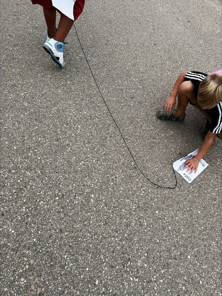 students measuring on blacktop