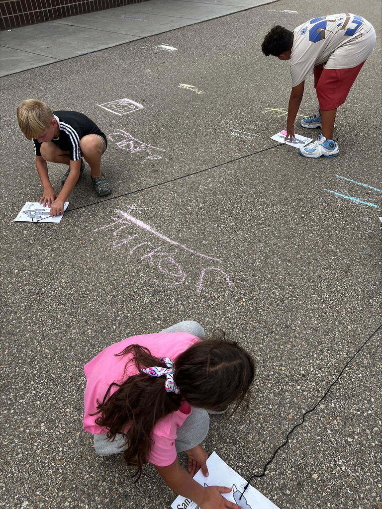 students measuring on blacktop