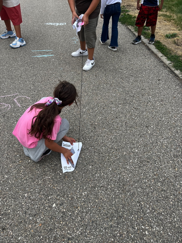 students measuring on blacktop