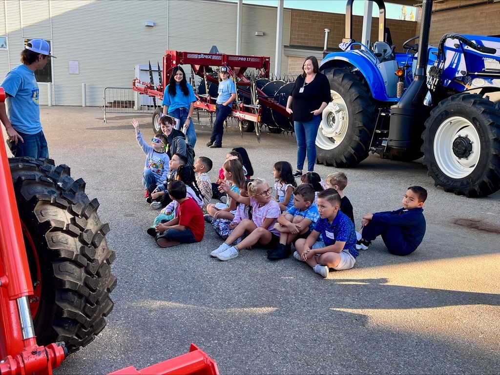 Children learning about a tractor