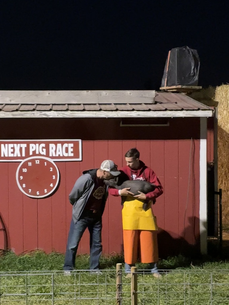 Man kissing a pig