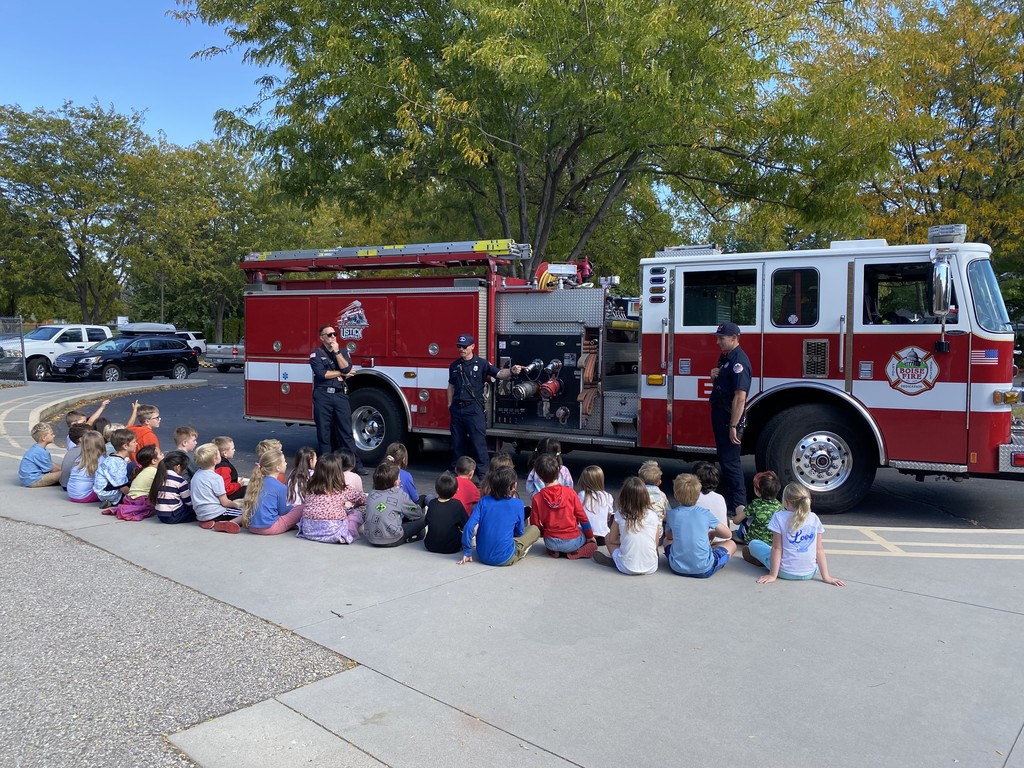 first graders learning from firemen