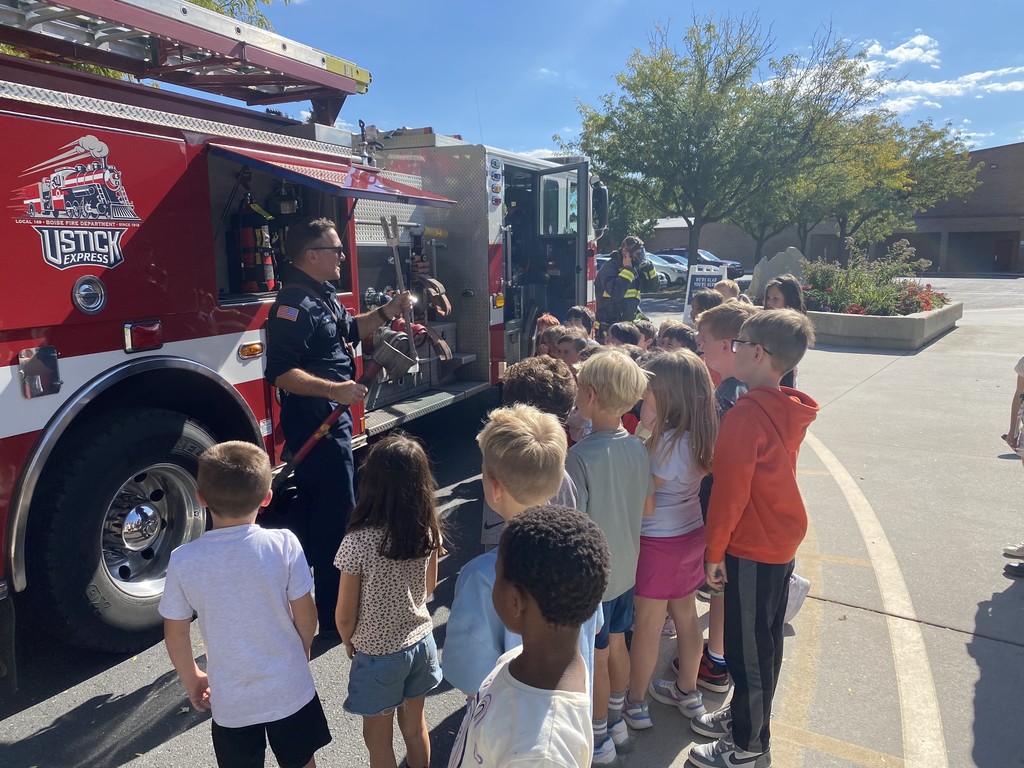 first greaders learning from firemen outside