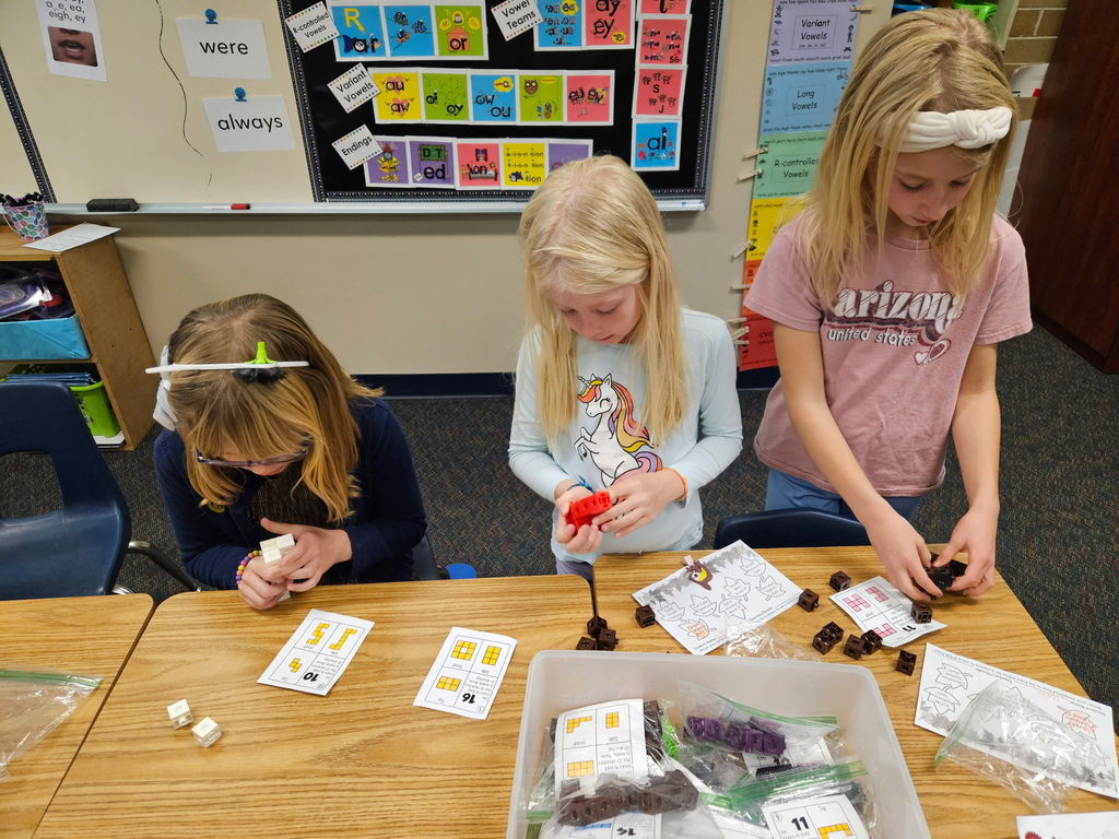 Girls build with blocks to create shapes on stem night