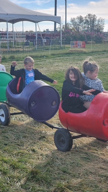 Kids riding  barrel train