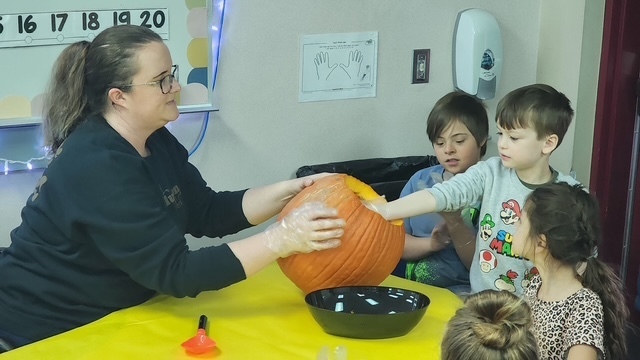 students exploring a pumpkin