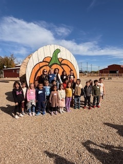 kids in front of gaint pumpkin