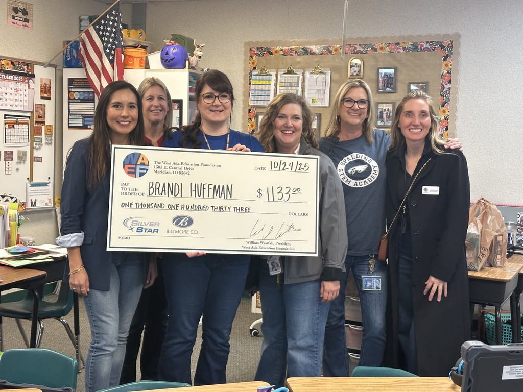 West Ada Foundation members presenting a check to Mrs Huffman for $1133