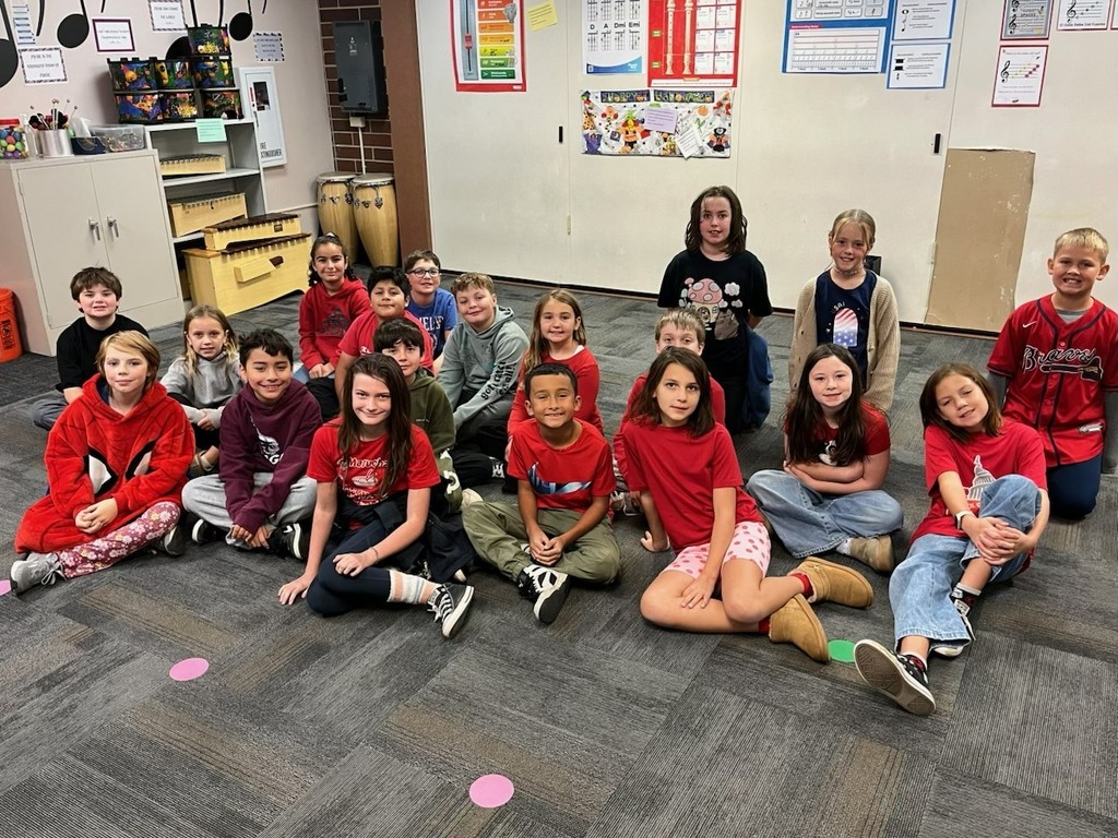 students sitting on rug