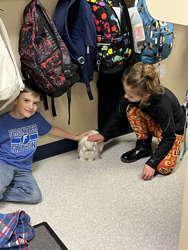 4th grade students petting the bunny