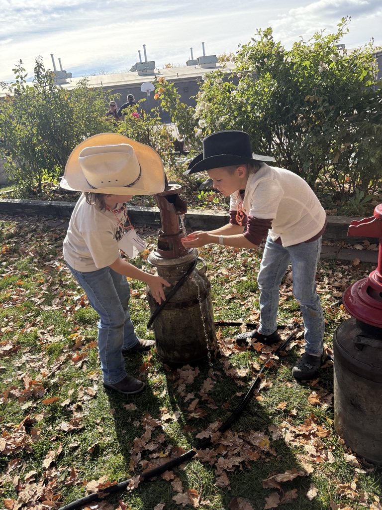 An image of students using a water pump