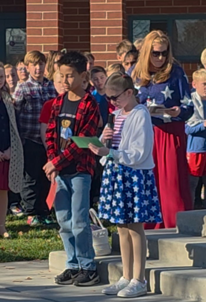 Students have a speech for the veterans at the flagpole