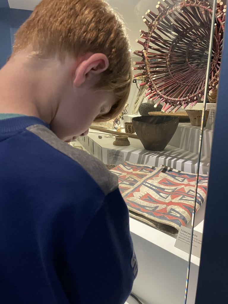4th grader looking at the Native American display at the museum 