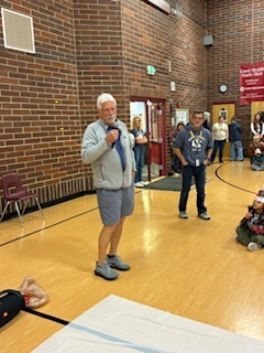 man speaking in a gy,m