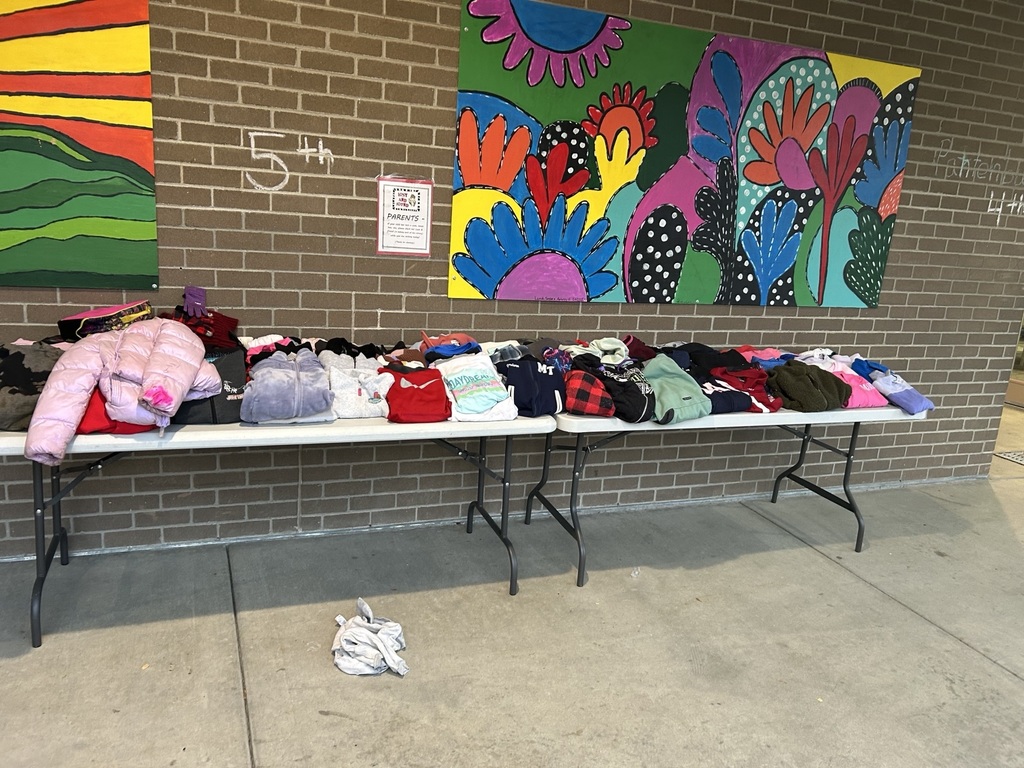 image of clothing on tables in front of the school