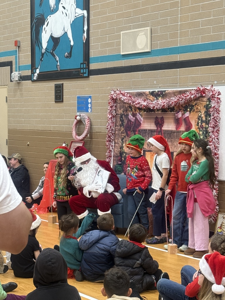 Image of students dressed as elves with Santa
