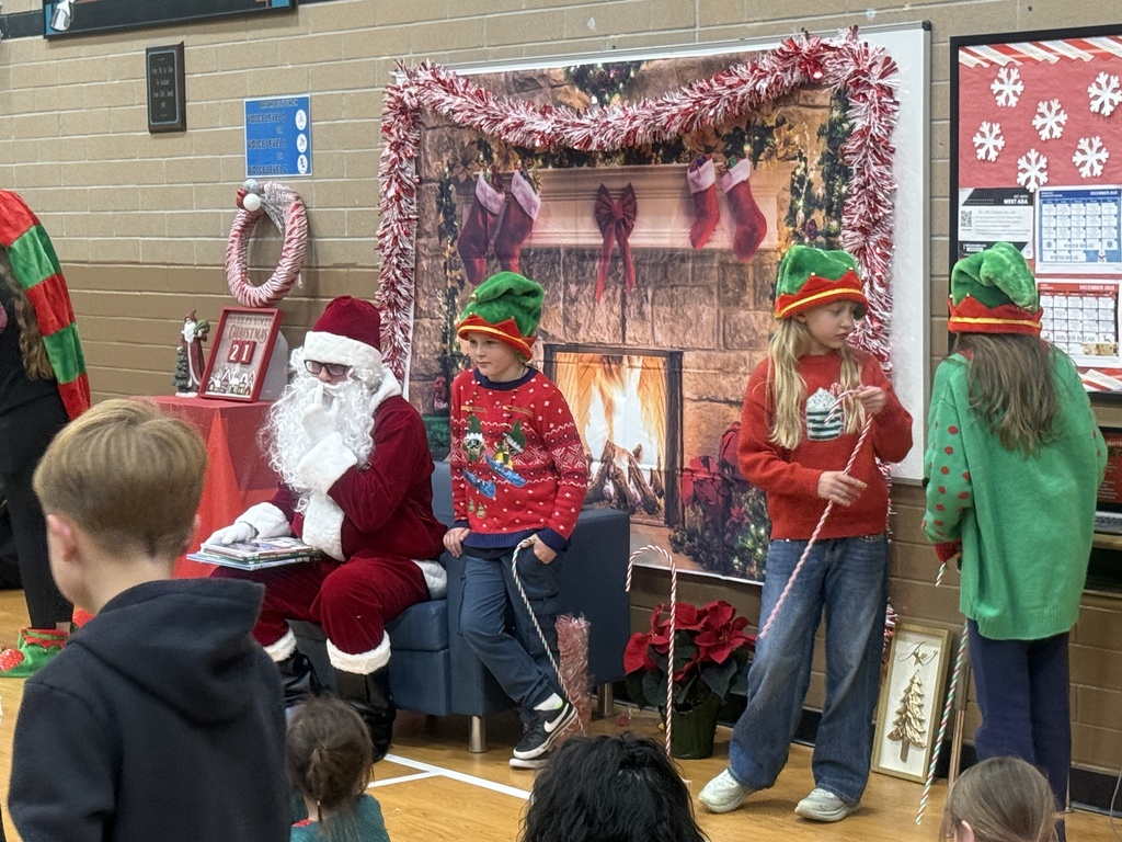 Image of students dressed as elves with Santa