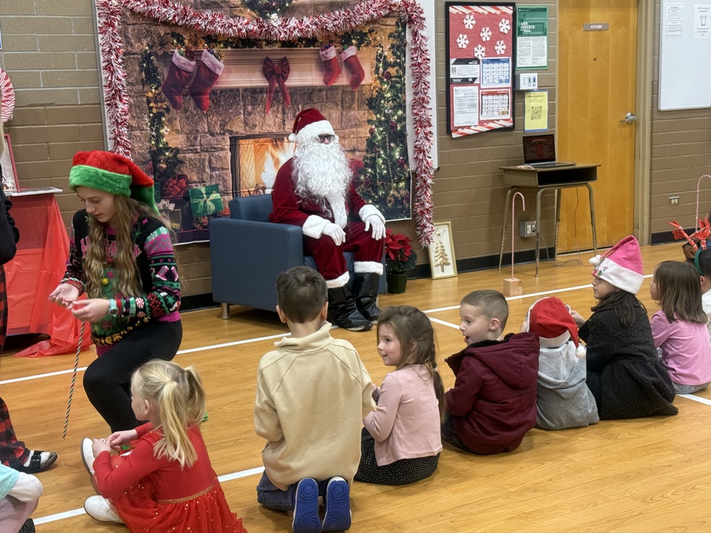 Image of students listening preparing to listen to a story from Santa