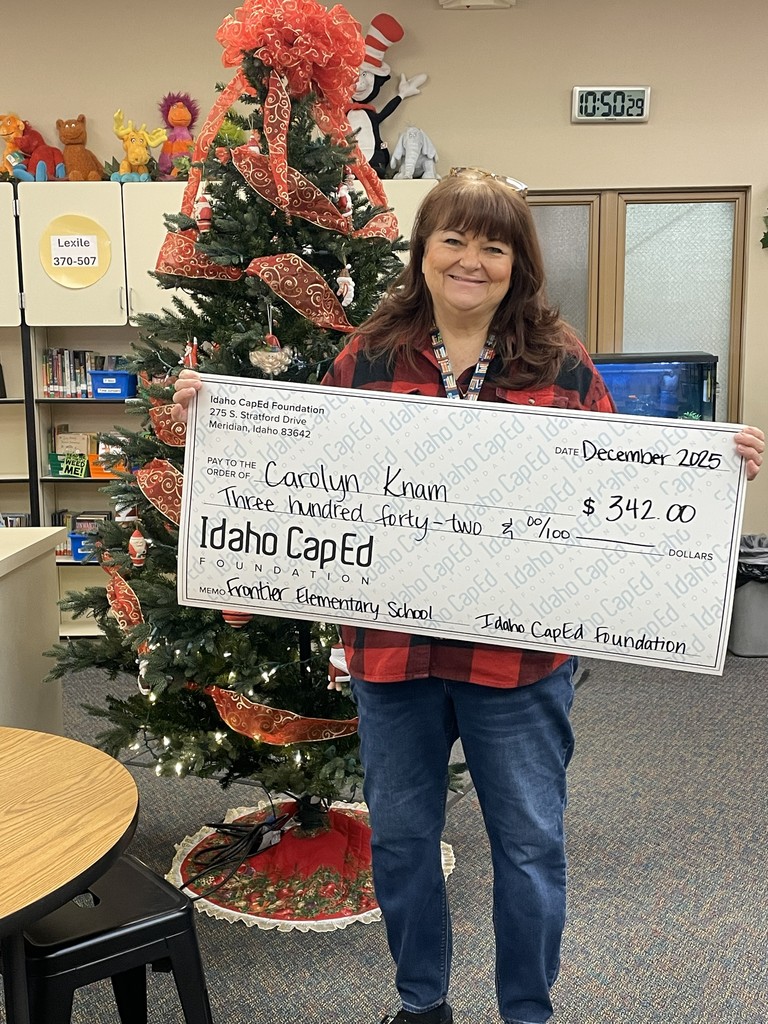 Mrs. Knam with her check from CapEd