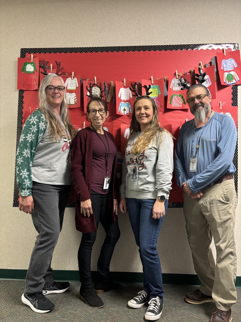 4th grade teachers with tree topper hats that are reindeer