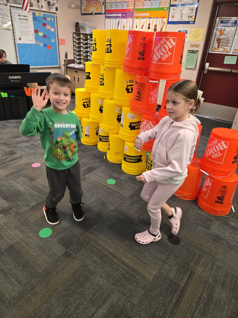 kids in school with yellow and orange buckets