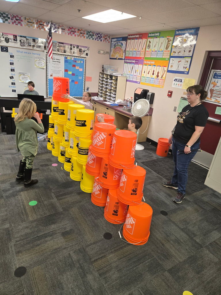 kids in school with yellow and orange buckets