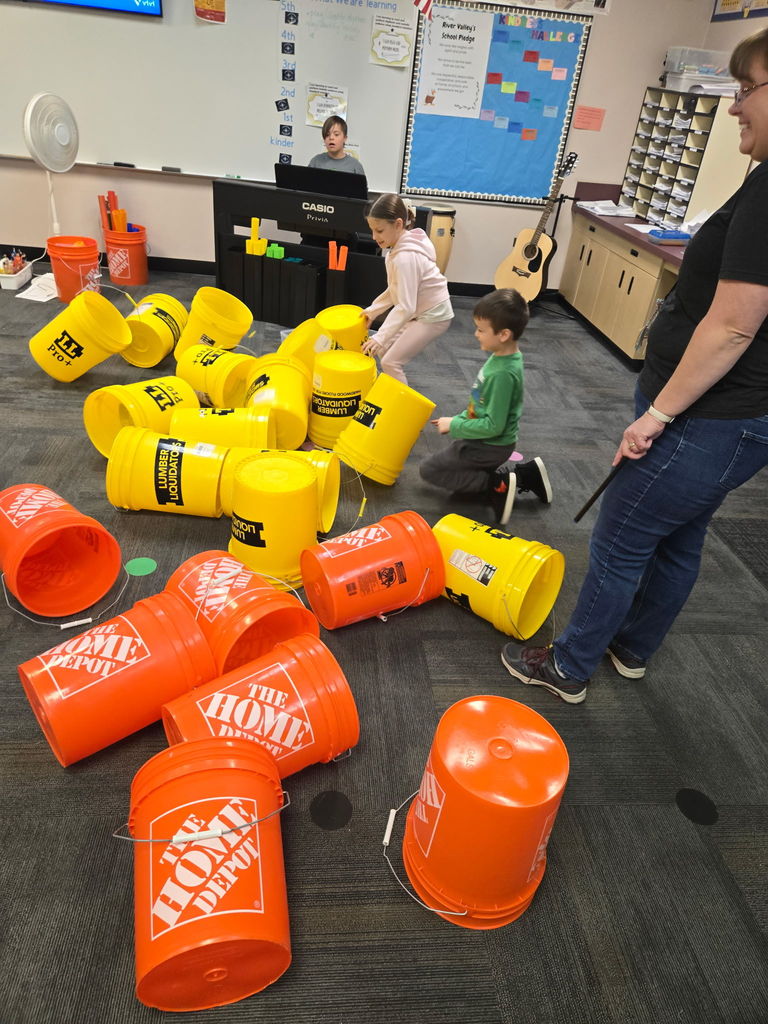 kids in school with yellow and orange buckets