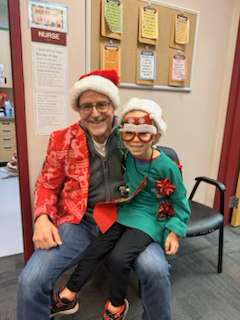 Student and principal dressed up in hiliday wear