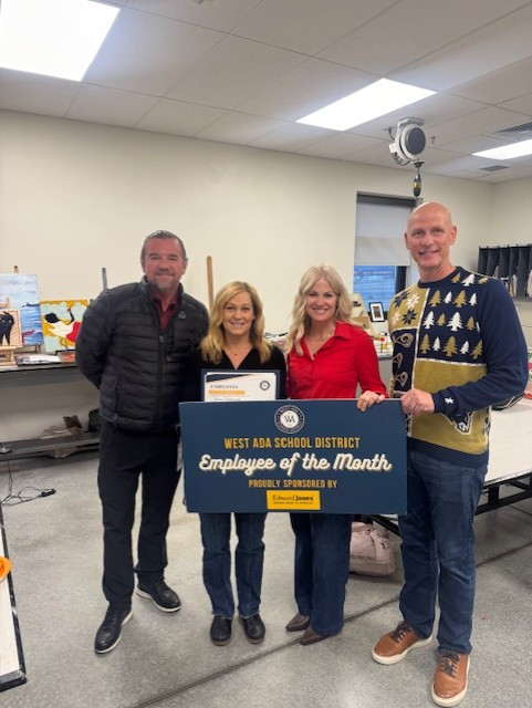 Jenny V and district representatives present the Employee of the Month