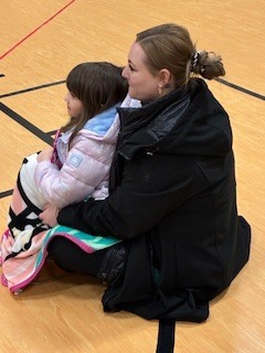 child sitting on parent's lap