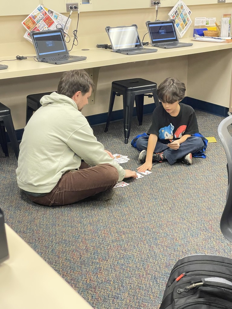 Staff and students playing card games. 