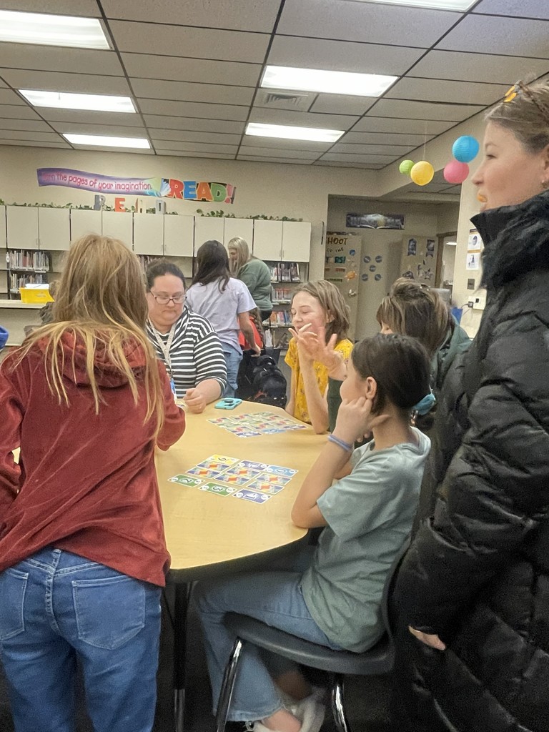 Staff and students playing card games. 