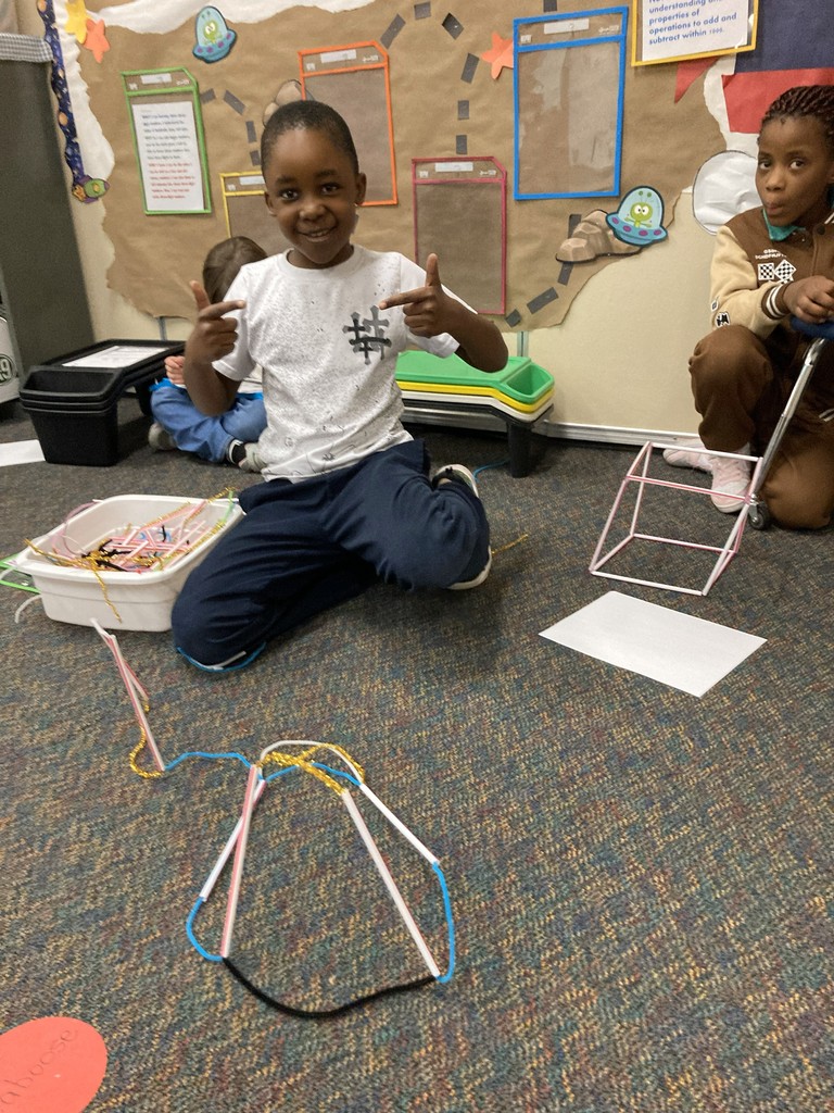 2nd graders building his "floor is lava" stem project