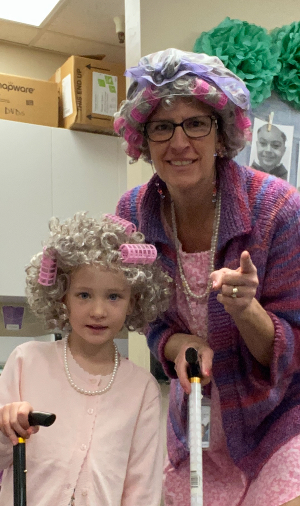 an image of a student and a teacher dressed like they are 100