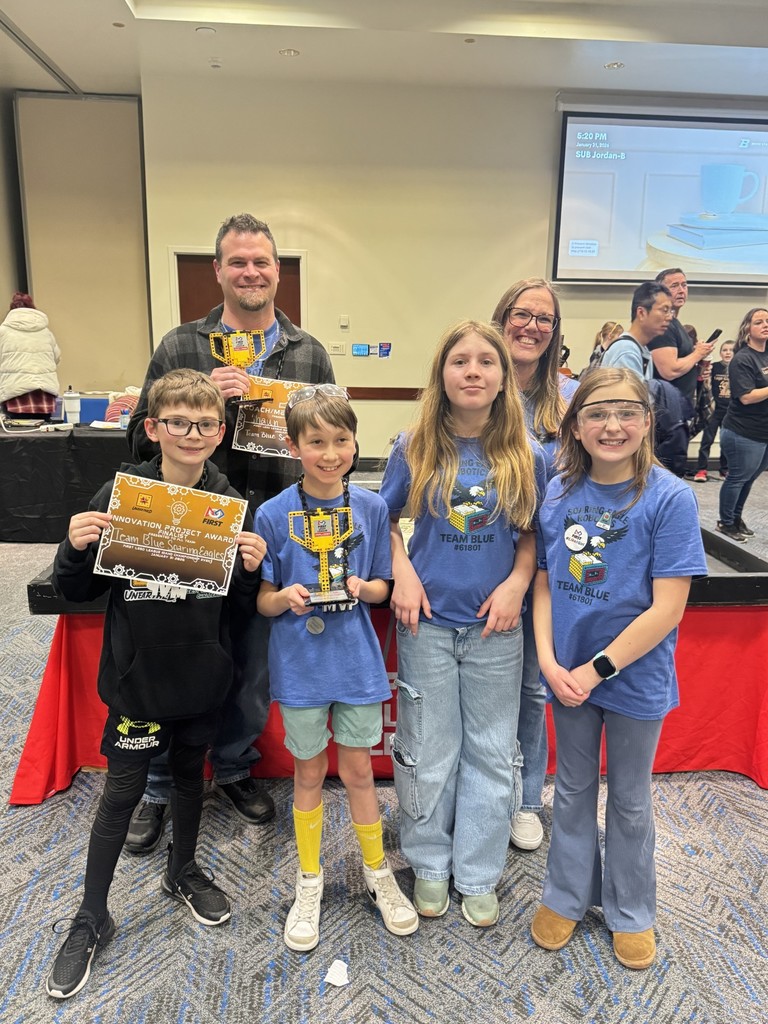 Mrs. Hunt with robotics team and trophy