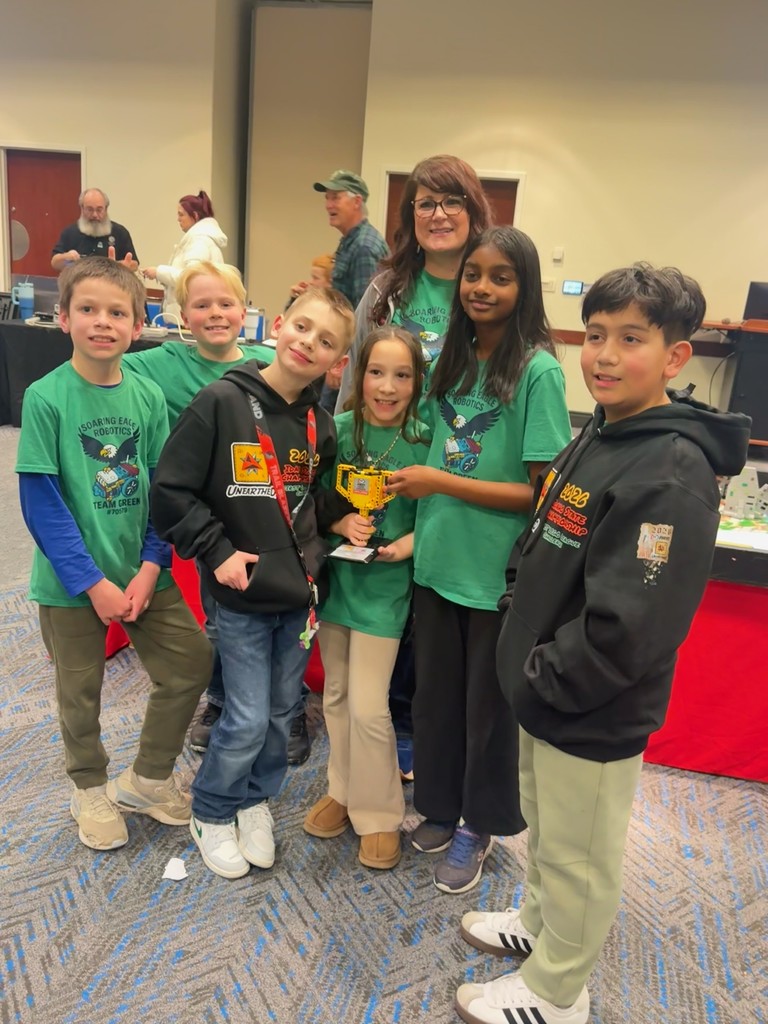 Huffman and robotics team with trophy