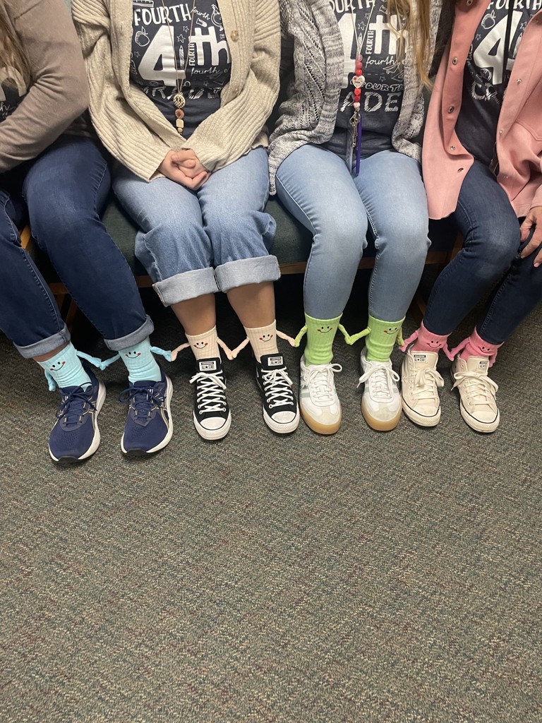 Close up of the friendship socks. They have arms that hang and magnets inside the hands that attach to eachother