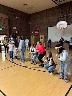 people dancing in a gymnasium