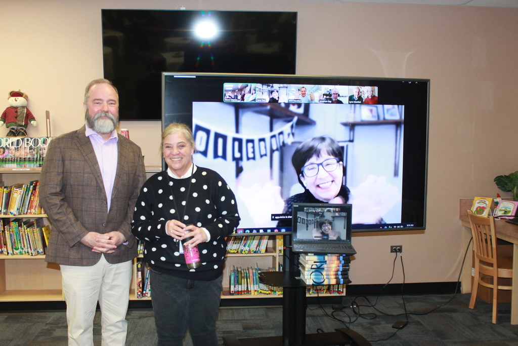people in front of large tv