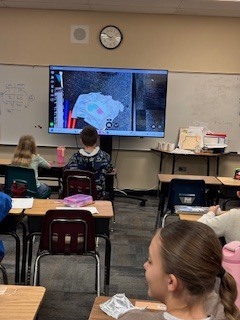 students following directions on a tv