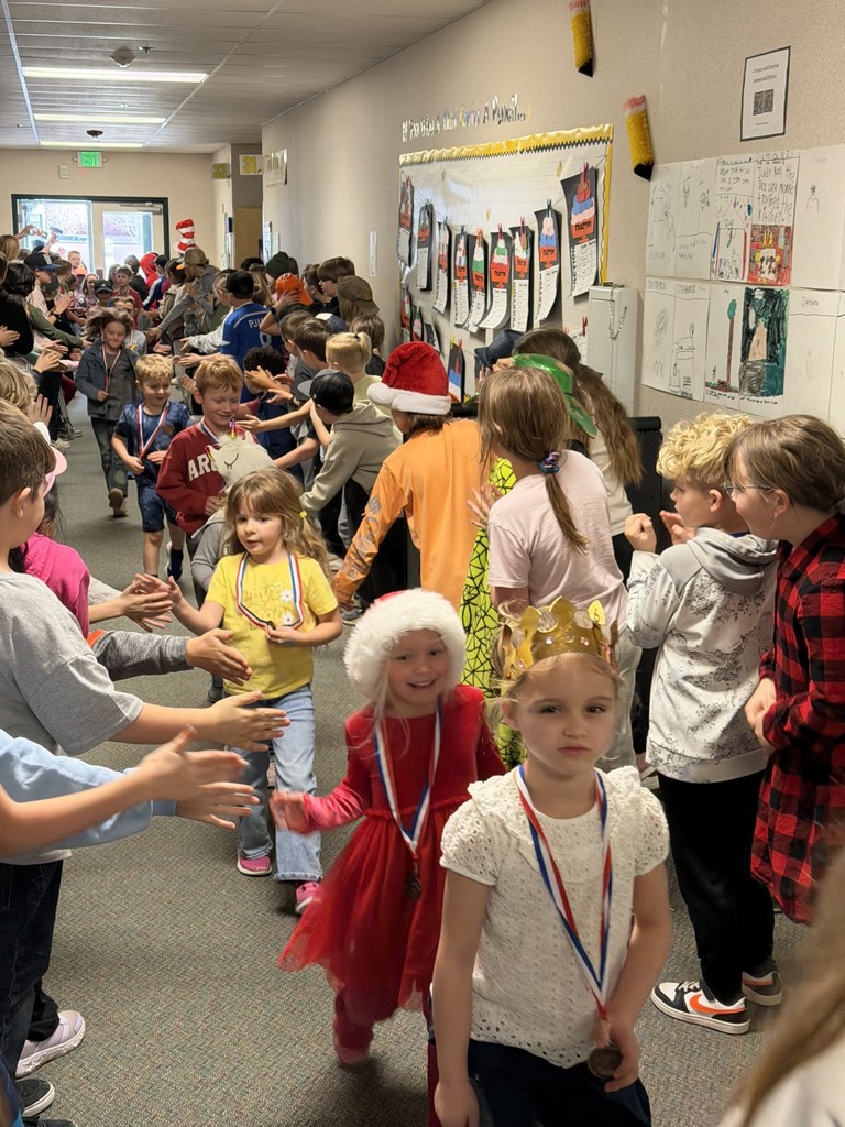 procession of top readers in the hallway. students high five-ing as they walk along