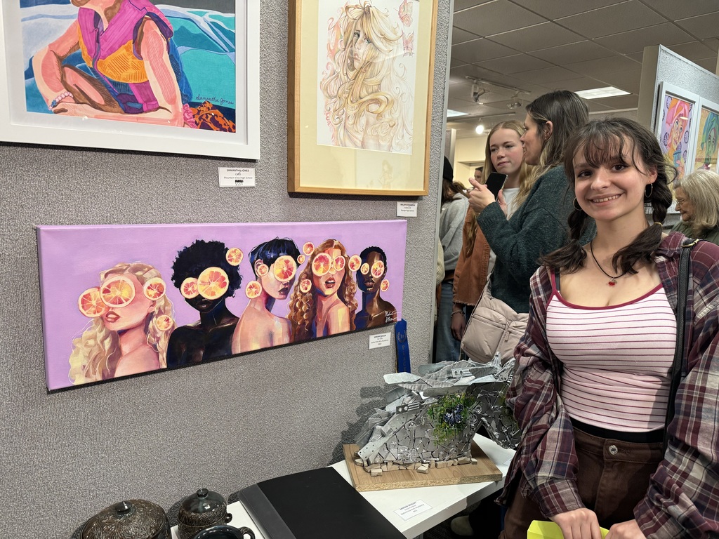 Miriam Mason standing by her artwork.