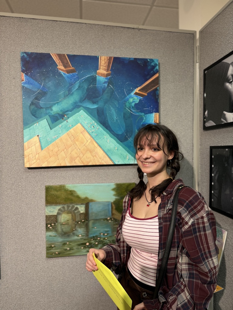 Miriam Mason standing by her artwork.