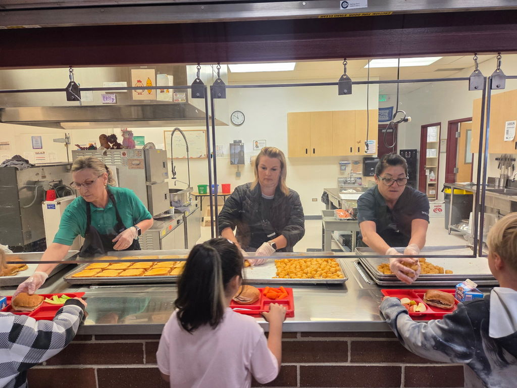 women in a cafeteria serving line